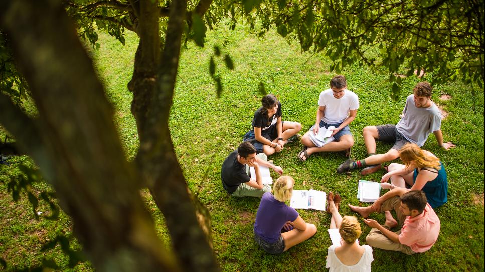 group of 8 people sat in circle in therapy session